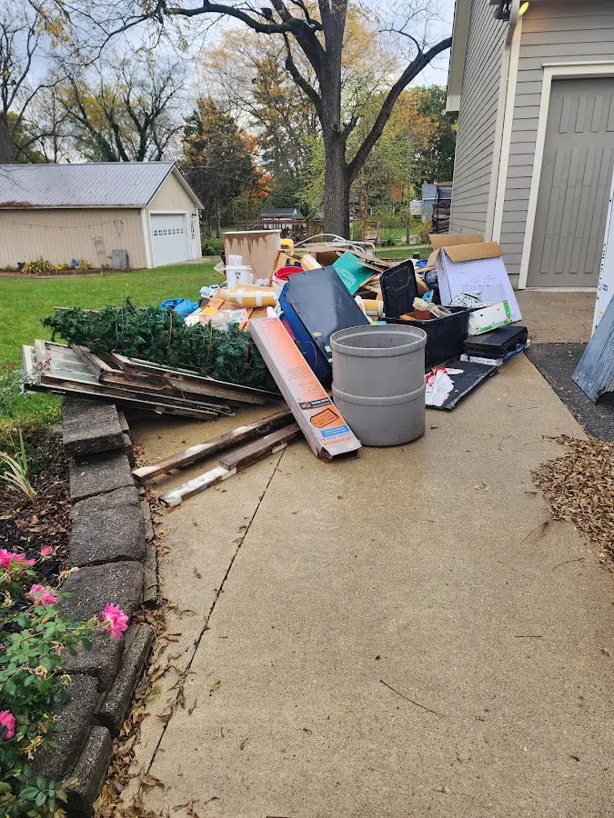 Dumpster being loaded with debris for 3 Yard Dumpster Rental in Coeur d'Alene